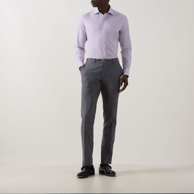 Model wearing a lilac dress shirt with grey tailored trousers and black leather shoes