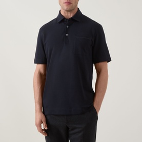 Model wearing Zegna navy polo shirt in linen, cashmere and silk blend, with chest pocket and short sleeves, styled with dark trousers