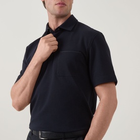 Model wearing Zegna navy polo shirt in linen, cashmere and silk blend, with short sleeves and chest pocket detail