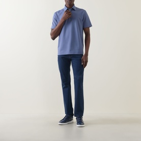 Model wearing Zegna Stitch Logo Polo Shirt in lilac with dark blue jeans and navy trainers. Classic collar, short sleeves, chest logo detail.