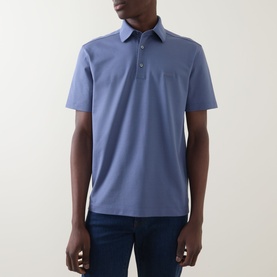 Model wearing Zegna Stitch Logo Polo Shirt in lilac, featuring classic collar, button fastening, chest pocket, and short sleeves, styled with dark