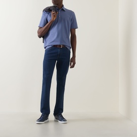 Model wearing Zegna Stitch Logo Polo Shirt in lilac, styled with dark blue jeans, brown belt and navy trainers