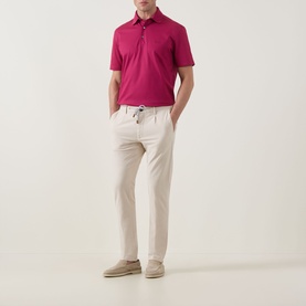 Model wearing Zegna dark pink cotton polo shirt, styled with stone drawstring trousers and tan suede loafers