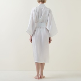 Model wearing Olivia von Halle Tie-Fastening Silk Robe in Ivory Core, shown from behind with wide sleeves and self-fabric tie belt.