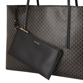Calvin Klein Monogram Logo Tote Bag in black with all-over logo pattern, gold-tone zip, and matching black pouch clutch