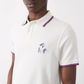 Model wearing Barbour Lure Logo Polo Shirt in Whisper White with multicolour tipped collar, cuffs, and chest embroidery detail.