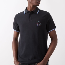 Model wearing Barbour Lure Logo Polo Shirt in Dark Navy with tipped collar and cuffs, featuring multicolour lure embroidery chest detail