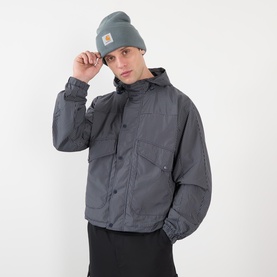 Model wearing grey hooded jacket with chest pockets, styled with a grey Carhartt beanie and black trousers