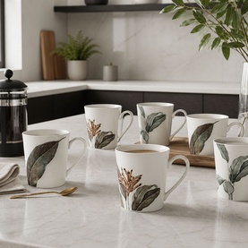 Mindy Browne Birds of Paradise Cups Set of Six, white bone china mugs with grey and green botanical leaf print, styled on kitchen counter