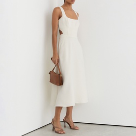 Model wearing Reiss white sleeveless midi dress with square neckline and cutout back, styled with tan heels and brown mini handbag