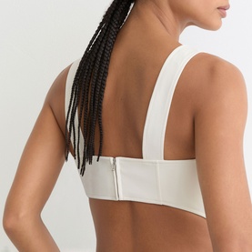 Model wearing Reiss white crop top, back view showing zip fastening and wide shoulder straps