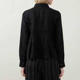 Model wearing InWear Dilana Pleated Linen Shirt in black, rear view showing dart detailing and flared hem, styled with striped trousers