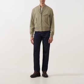 Model wearing Belstaff Carrier Water-Repellent Bomber Jacket in green with navy trousers and brown loafers.
