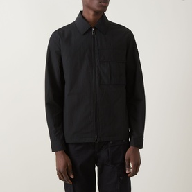 Model wearing Belstaff Compact Technical Cargo Overshirt in black with pointed collar, two-way zip and chest patch pocket.