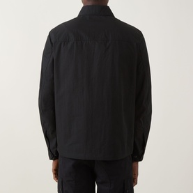 Model wearing Belstaff Compact Technical Cargo Overshirt in black, rear view showing relaxed fit, long sleeves, and snap button cuffs