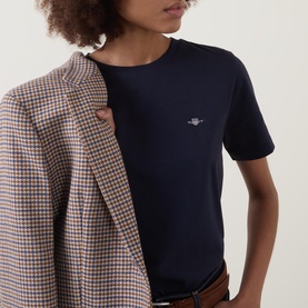 Model wearing Gant Shield Logo T-Shirt in navy, crew neck, short sleeves, styled with a houndstooth blazer and brown belt