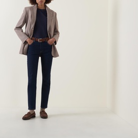 Model wearing Gant Shield Logo T-Shirt in navy with V neckline, styled with dark jeans, taupe blazer, and brown loafers