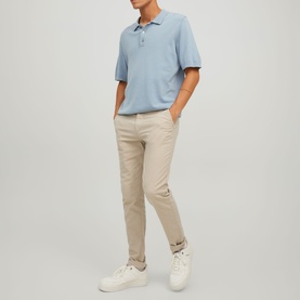 Model wearing Jack & Jones Dune chino trousers with a light blue polo shirt and white trainers.