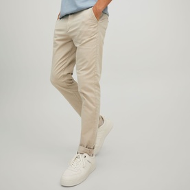 Model wearing Jack & Jones Dune chino trousers, styled with a light blue top and white trainers.
