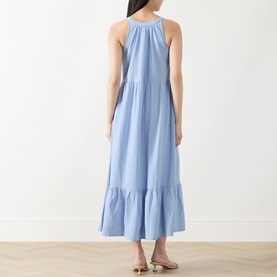 Model wearing Part Two Light Blue halterneck tiered maxi dress, shown from back, with nude strappy sandals
