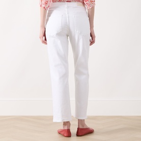 Model wearing Part Two Judyas Cropped Straight Leg Jeans in white, rear view, styled with a floral top and red flat shoes.