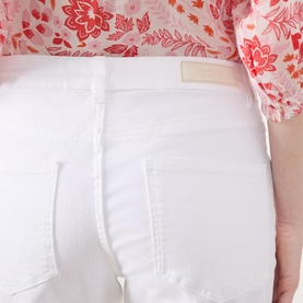 Model wearing Part Two Judyas Cropped Straight Leg Jeans in white, showing rear logo badge and five-pocket detail, styled with a pink floral top.