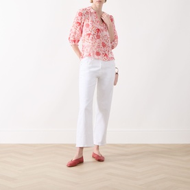 Model wearing Part Two Judyas Cropped Straight Leg Jeans in white, styled with a red floral blouse and red loafers.