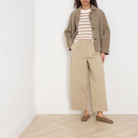 Model wearing Part Two Belisia Striped Sweater in beige, styled with wide-leg trousers, a jacket, and loafers.