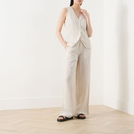 Model wearing Part Two cream striped linen-viscose waistcoat with matching wide-leg trousers and black flat sandals