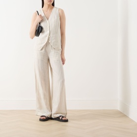 Model wearing Part Two cream stripe linen-blend waistcoat top with matching wide-leg trousers, styled with black sandals and small shoulder bag.