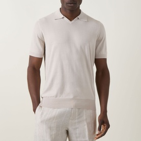 Model wearing B Cucinelli Fine Knit Polo Shirt in Juta, featuring open flat collar, short sleeves and ribbed trims, styled with linen trousers