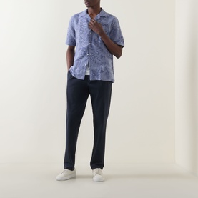 Model wearing Boggi Milano Jacquard Print Shirt in navy blue with camp collar and short sleeves, styled with navy trousers and white trainers.