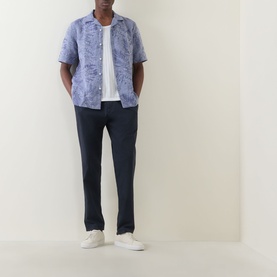 Model wearing Boggi Milano Navy Blue Jacquard Print Shirt with camp collar, styled with navy trousers and white trainers.
