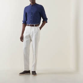 Model wearing Boggi Milano navy blue linen casual shirt with white pleated trousers and brown loafers