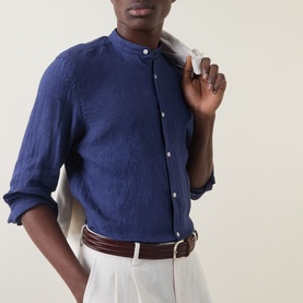 Model wearing Boggi Milano navy blue linen casual shirt with grandad collar, styled with white trousers and brown leather belt.