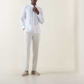 Model wearing Boggi Milano white linen casual shirt with mandarin collar, styled with cream trousers and sand suede loafers