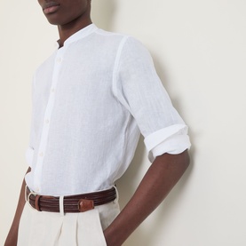Model wearing Boggi Milano white linen casual shirt with mandarin collar and rolled sleeves, styled with cream trousers and brown woven belt.