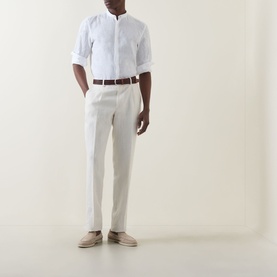 Model wearing Boggi Milano white linen casual shirt with mandarin collar, rolled sleeves, styled with cream trousers and brown belt.
