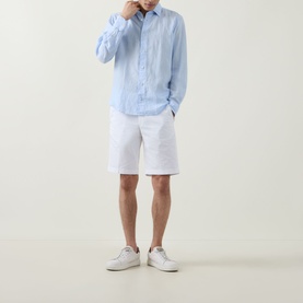 Model wearing Boggi Milano light blue linen-blend casual shirt with white shorts and white trainers