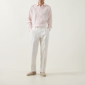 Model wearing Boggi Milano Solid Classic Shirt in light pink with white pleated trousers and beige suede loafers.