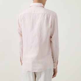 Model wearing Boggi Milano Solid Classic Shirt in light pink linen blend, rear view, long sleeves with buttoned cuffs, styled with white trousers.