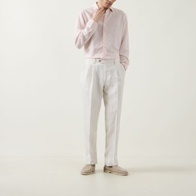 Model wearing Boggi Milano Solid Classic Shirt in light pink with white trousers and beige suede desert boots.