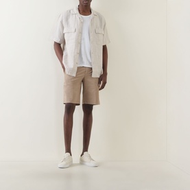 Model wearing Boggi Milano sand linen casual shirt with chest pockets, styled with beige shorts and white trainers.