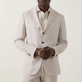 Model wearing Boggi Milano Herringbone Single-Breasted Blazer in sand, styled with matching trousers and open-collar shirt