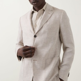 Model wearing Boggi Milano Herringbone Single-Breasted Blazer in sand, styled with a matching open-collar shirt. Notched lapels, button fastening