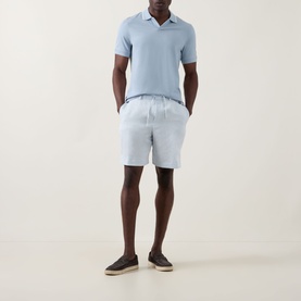 Model wearing Boggi Milano S-Caf&eacute;&reg; Logo Piqu&eacute; Polo Shirt in light blue with open collar, styled with light blue shorts and dark espadrilles.