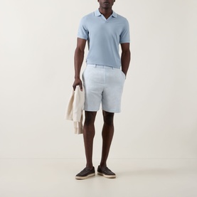 Model wearing Boggi Milano S-Caf&eacute;&reg; Logo Piqu&eacute; Polo Shirt in light blue with tipped collar, styled with light blue shorts and dark espadrilles.