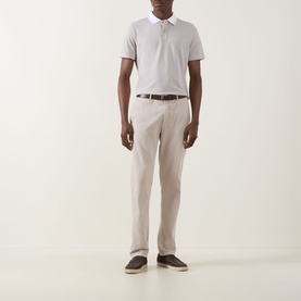 Model wearing Boggi Milano S-Caf&eacute;&reg; Piqu&eacute; Polo Shirt in sand with contrast collar, styled with beige trousers and brown belt.