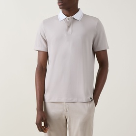 Model wearing Boggi Milano S-Caf&eacute;&reg; Piqu&eacute; Polo Shirt in sand, with white contrast collar, two-button placket and short sleeves, styled with beige