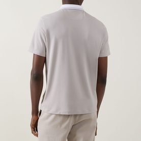 Model wearing Boggi Milano S-Caf&eacute;&reg; Piqu&eacute; Polo Shirt in sand, rear view, with contrast tipped collar and straight hem, styled with beige trousers.